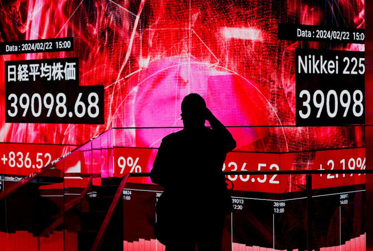 A visitor takes photos of an electronic screen displaying Japan's Nikkei share average in Tokyo, Japan, February 22 2024. Picture: ISSEI KATO/REUTERS