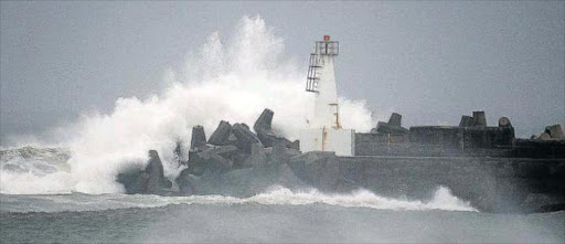 MONSTER ASSAULT: Massive waves slam into the harbour wall during fierce weather the past two days Picture: MARK ANDREWS