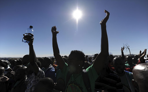 Miners singing and chanting songs at Nkaneng behind the Lonmin mine. File photo.