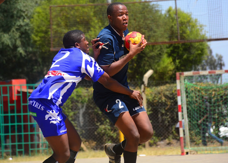 Boomerang's Robert Osano (L) tackles Collins Snox of Kenya University in a past match