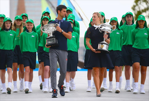Current Australian Open tennis champions Serbia's Novak Djokovic and Germany's Angelique Kerber walk together as they hold the tournament trophies ahead of the official draw ceremony in Melbourne, Australia, January 13, 2017. Picture credits: Reuters