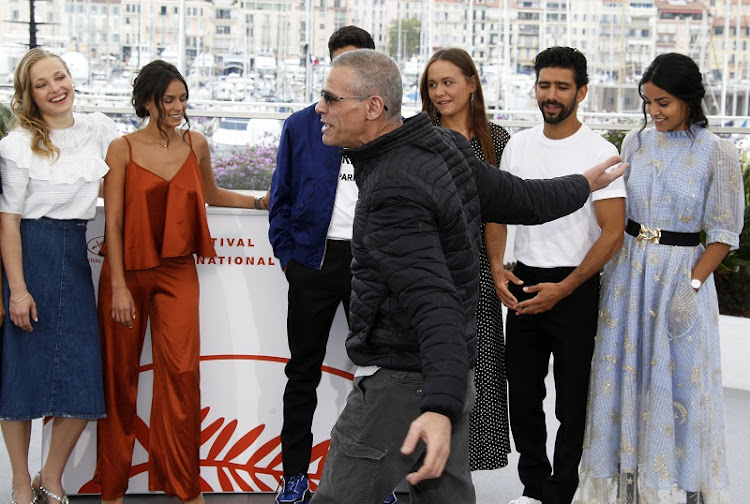 Director of "Mektoub My Love: Intermezzo" Abdellatif Kechiche poses with cast members.