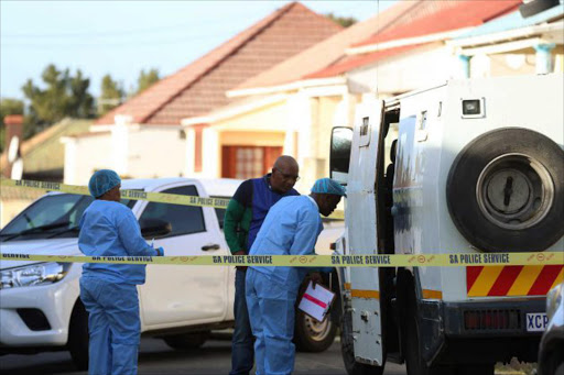 Members of the SAPS at the scene in Usher Street, in Southernwood, where a SBV cash in transit van was dumped by robbers after being targeted while at nearby Malcolmess Park yesterday Picture: MARK ANDREWS