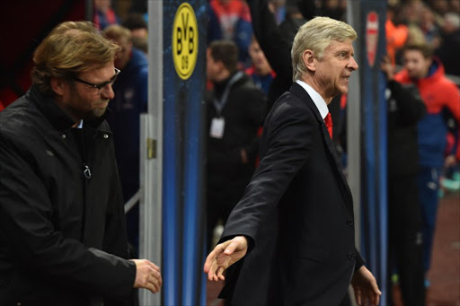 Dortmund's head coach Juergen Klopp (L) is greeted by Arsenal's French manager Arsene Wenger (R) before the UEFA Champions League Group D football match between Arsenal and Borussia Dortmund at the Emirates Stadium in north London on November 26, 2014.
