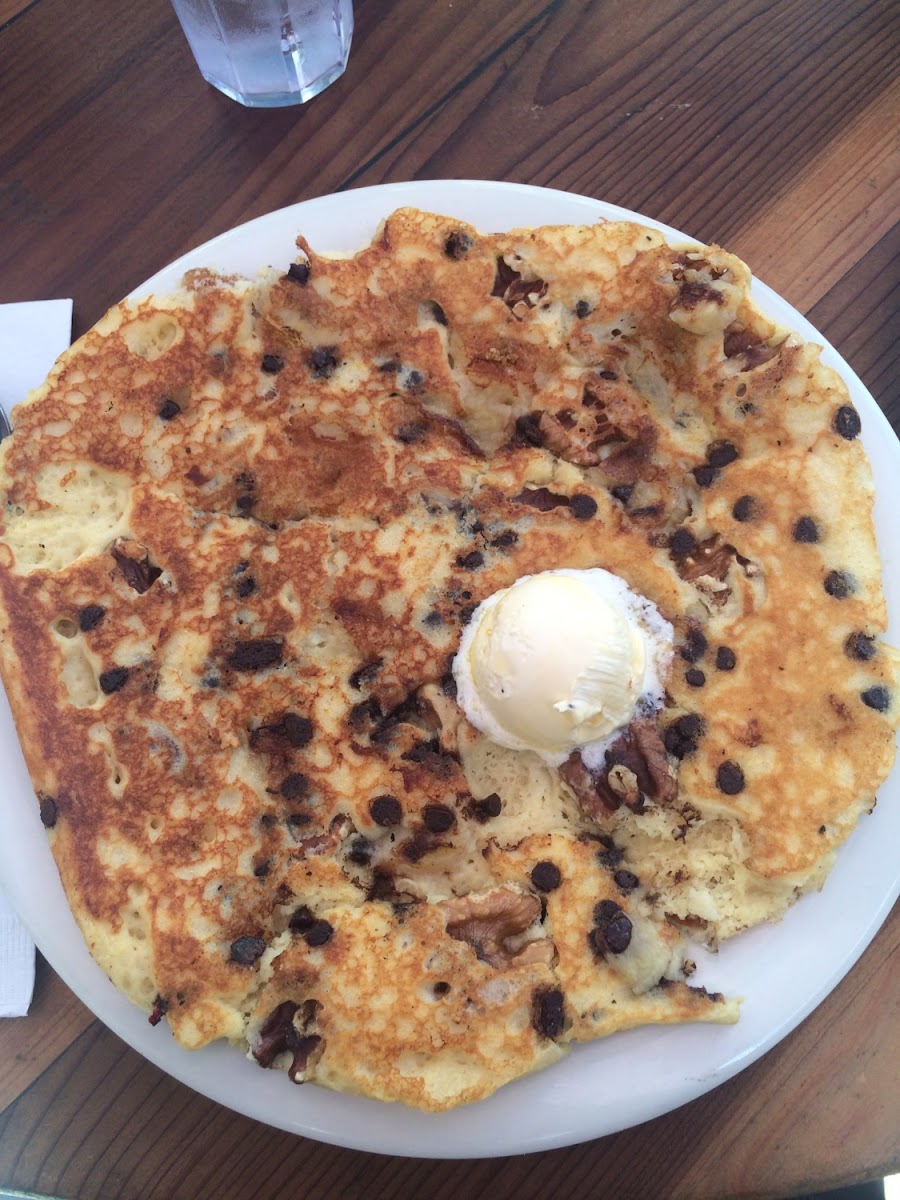 Gluten free pancake as big as the plate! "The Monkey Wrench" aka banana, chocolate chips, and walnuts.