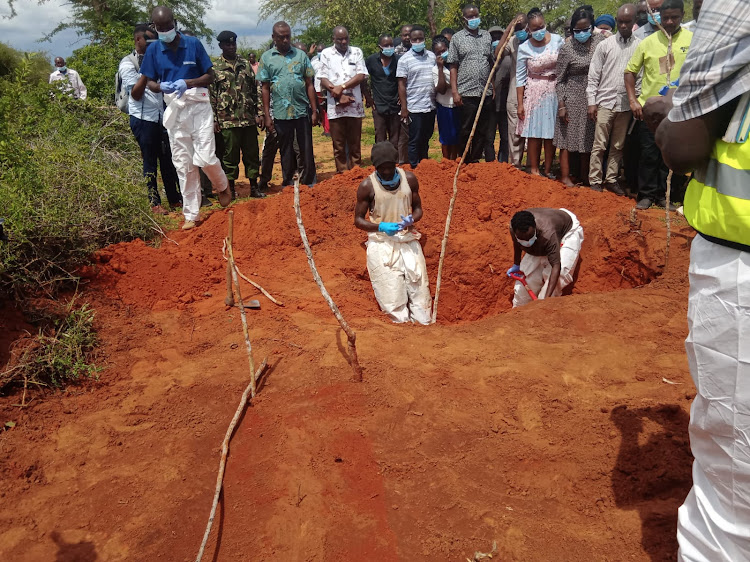 Security officers exhume bodies from shallow graves at Shakahola in Kilifi county on April 25, 2023.