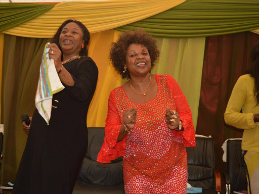 Mombasa senator aspirant on Jubilee ticket Hazel Katana joins Pastor Esther Obasi-Ike in a dance at break through chapel in Nyali Mombasa on Saturday during a thanks giving service. / JOHN CHESOLI