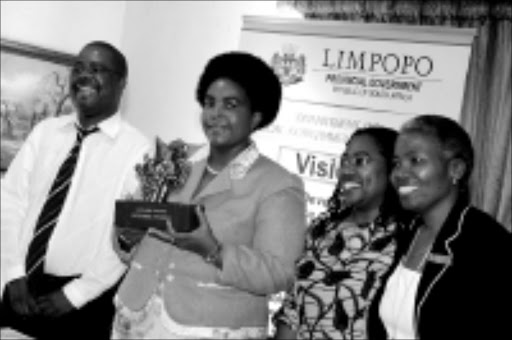 WELL DONE: Ngoako Molokomme, MEC Maite Nkoana Mashabane, with trophy, Hunang Mashimbye and Morongoa Ramphele at the National Govan Mbeki Housing Awards recently. Pic. Elijar Mushiana. 15/10/08. © Sowetan.