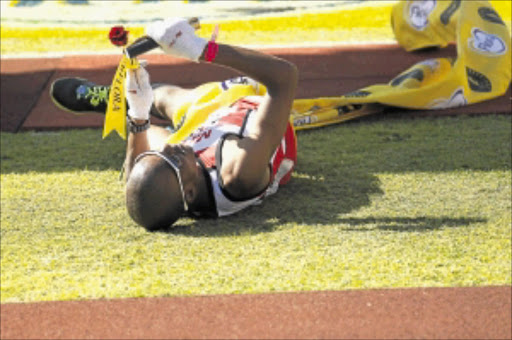 ROSY FALL: Ludwick Mamabolo collapses at the finish line after winning the 2012 Comrades Marathon in Durban . Mamabolo became the first South African to win the Pietermaritzburg-to-Durban race since 2005. Photo: Gallo Images