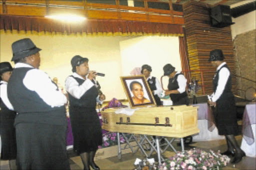 CRUEL END: Mourners sing hymns as they try to uplift the spirit of friends and family of the late Maureen Gege at the Carletonville Civic Centre on Saturday. PHOTO: SIBUSISO MSIBI