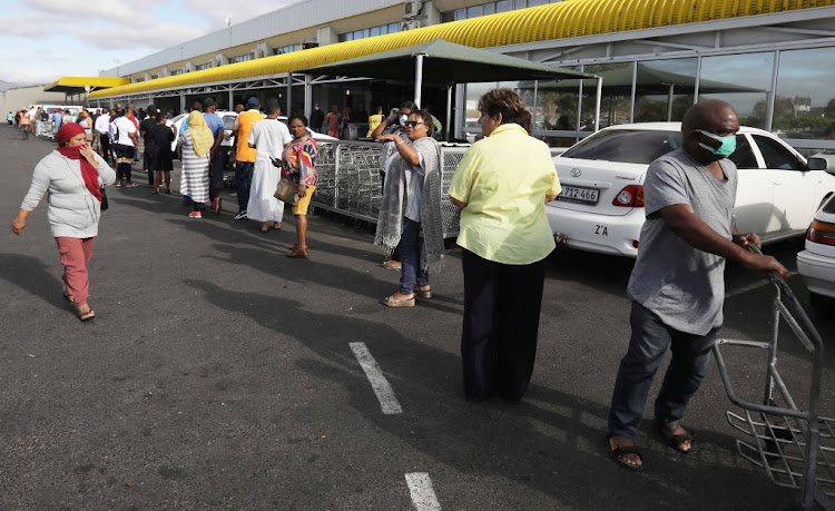 ​Long queues form outside Makro in Otterey, Cape Town, on March 25 2020, as people shop before SA goes into lockdown.