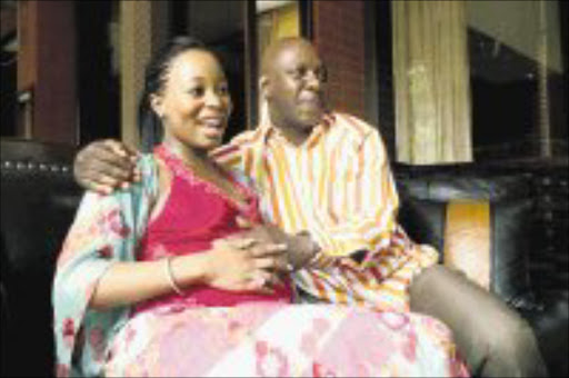 BABY GIRL: Khanyisile Mbau and Mandla Mthembu. Pic: Antony Kaminju. Circa November 2006. © Sunday Times.
