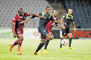 SQUELCH: Tsietsi Mahoa and Sandile Sibande of Moroka Swallows battle for the ball with Mogakolodi Ngeze of Platinum Stars during the Absa Premiership match at Dobsonville Stadium in Soweto on Saturday. Stars face log leaders Kaizer Chiefs tonight.