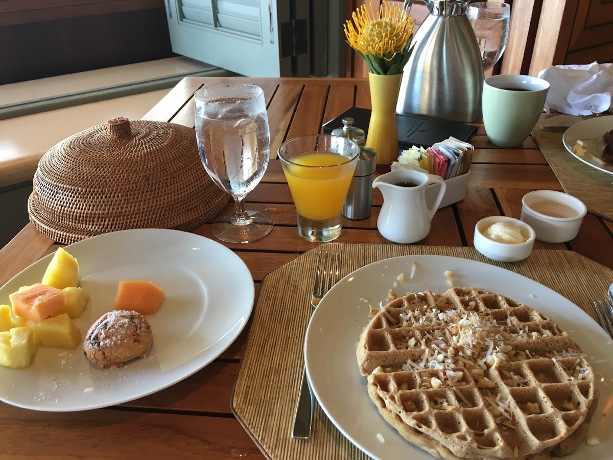 Gluten free waffle with toasted coconut and macadamia nuts, fresh fruit, gluten free cranberry orange scone