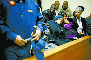 Andries  Tatane ’s widow, Rose, (left) is comforted by friends at the Ficksburg Magistrate’s Court. File photo.