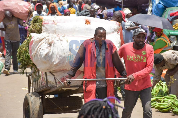 Kenyans carry on their daily activities prior to the 20222/23 budget reading in Nairobi CBD on April 7, 2022.