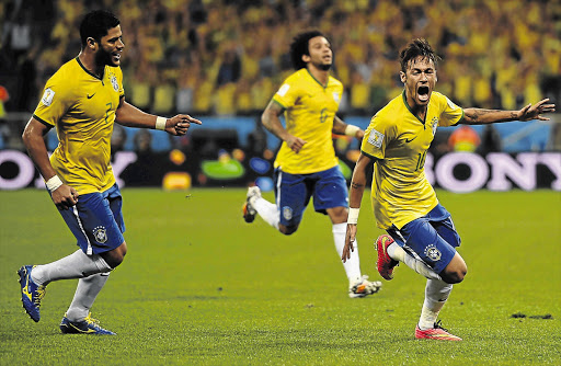 REMEMBER HIS NEYM: Brazilian striker Neymar, right, celebrates the first of his two goals in Brazil's 3-1 win over Croatia in the tournament opener at the Corinthians Arena in Sao Paulo.
