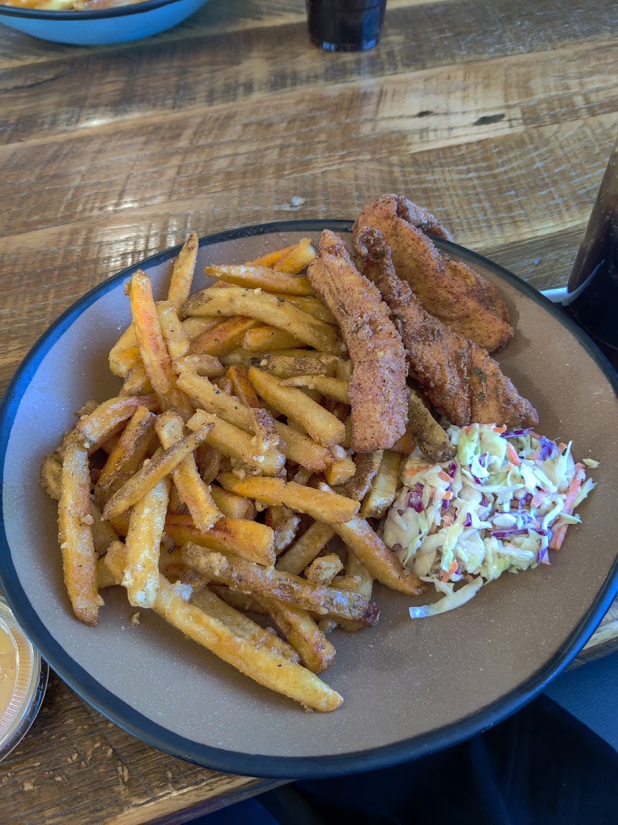 Chicken strips, garlic fries, and coleslaw