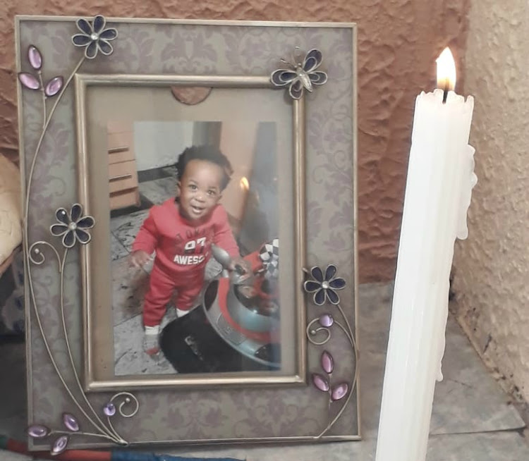 A framed picture of Langelihle Mnguni who was found, allegedly murdered, is placed on the floor in the bedroom where his mother, Lerato, 28, is grieving.