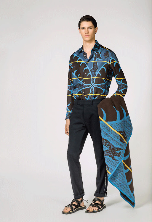 Louis Vuitton's Giraffe Printed Classic Shirt "features an abstract African blanket and giraffe design," according to the luxury brand's website. Here, it's paired with their Basotho Plaid throw.