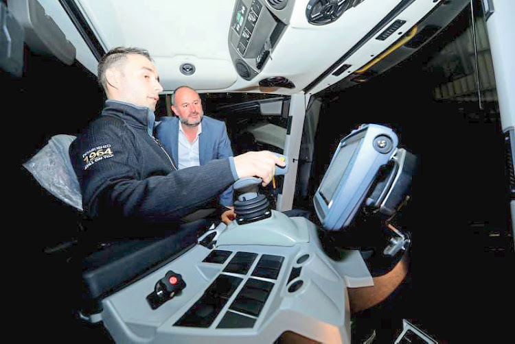 Heinrich Gerber at the controls of the salt harvester, with Nelson Mandela Bay mayor Retief Odendaal. Picture: Supplied