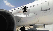 BLOWN OPEN: The hole in the fuselage of Flight D3159 is believed to have been caused by a bomb