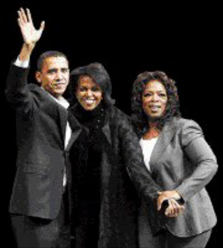HOPEFUL: Barack Obama, his wife Michelle and Oprah Winfrey. Pic. Brian Snyder. 09/12/07. © Reuters.