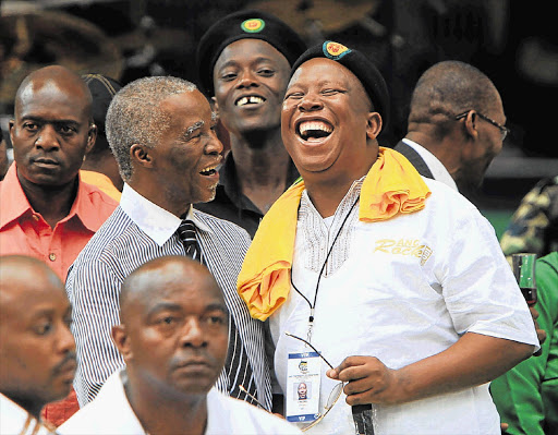 OUT OF THE MAIN SPOTLIGHT: Former president Thabo Mbeki and ANC Youth League president Julius Malema have a good laugh during the ANC's centenary celebrations at Mangaung in Bloemfontein yesterday Picture: SIMPHIWE NKWALI