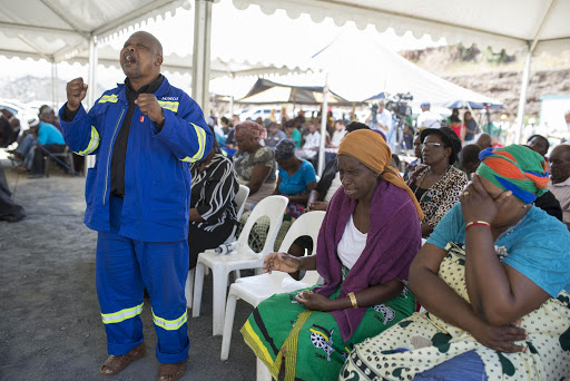 Veteran mineworker Themba Mnisi prays for the safe return of his daughter