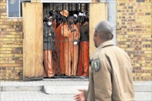 File photo: Boksburg Prison inmates peep through a reinforced steel door. PHOTO: Vathiswa Ruselo