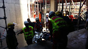 Paramedics help pull a man out of the building site in Sandton after a structural collapse left two injured on 15 November 2016.