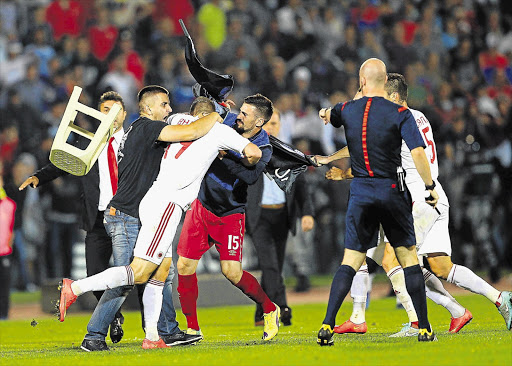 PITCHED BATTLE: Serbian and Albanian players get involved in a mass brawl after an Albanian flag was flown by a remote-controlled drone into the Partizan Stadium in Belgrade as the two countries clashed in a Euro 2016 qualifier