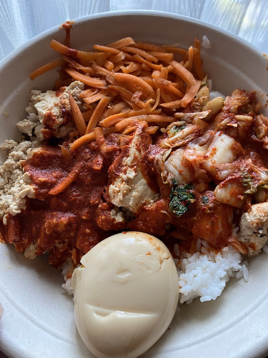 Tofu bowl with kimchi, carrots, gochujang, and soft boiled egg