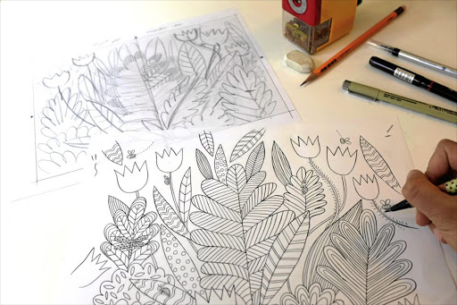 Artist Emma Farrarons creating an illustration for others to colour in.