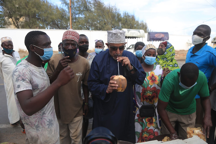 KenTrade chair Suleiman Shahbal tastes coconut milk at Light House near Mama Ngina Waterfront Park on Friday.