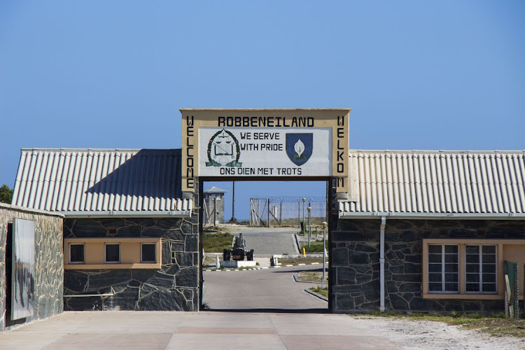 A Welcome to Robben Island sign at the harbour on the island.
