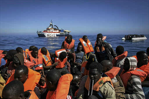 Refugees and migrants wait to be rescued from an overcrowded boat by crew members from a Migrant Offshore Aid Station vessel on Thursday off Lampedusa, Italy. The number of people attempting the dangerous central Mediterranean crossing from Libya to Italy has risen since this time last year.