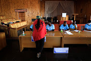 A voter with IEC officials in Alexandra, Johannesburg. 