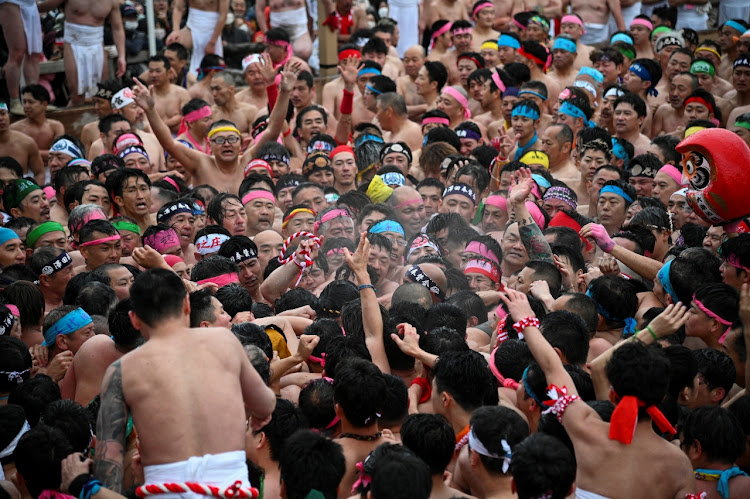 In the festival's main event, a large group of men push together to drive away evil spirits.