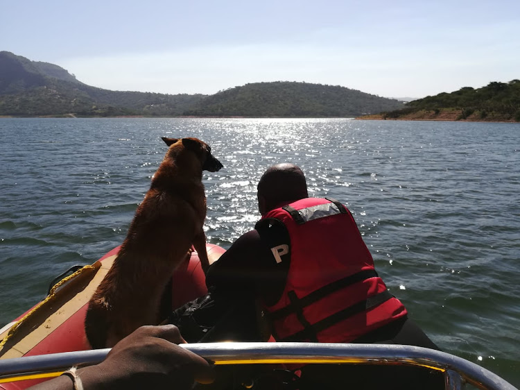 Police search dog Lea stands at the bow with Sergeant Mathews Phakathi as officers travel across Inanda dam in search of a 14-year-old drowning victim on Wednesday, December 12 2018.