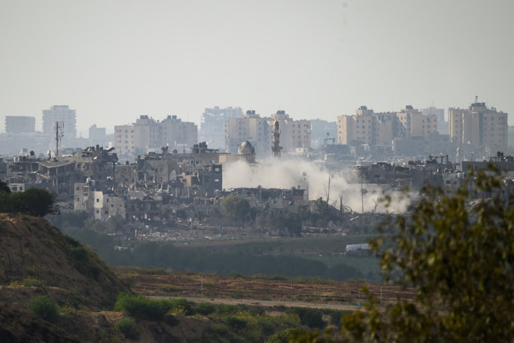 A plume of smoke rises following an artillery strike in Gaza. Picture: LEON NEAL