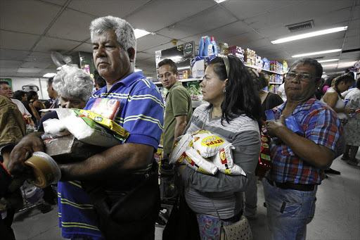 BETTER TO HOLD BONDS: While Venezuelans shopped for groceries across the border at a supermarket in Cucuta, Colombia last year because of major food shortages in their own country, investors were profiting mightily from Venezuelan debt.