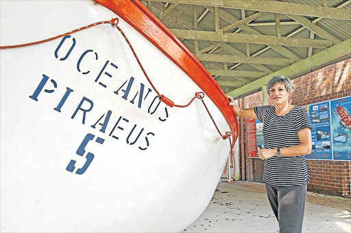 FREE ENTRY: East London Museum director Geraldine Morcom at the Oceanos lifeboat, which will be the centrepiece of a free talk about the 1991 Oceanos cruise ship rescue. The talk, at 10.30am on Saturday, is part of the Umtiza Arts Festival, which opens on Friday evening and runs until Sunday Picture: STEPHANIE LLOYD