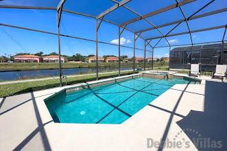 Sun-drenched, west-facing private pool and spa with a lake view at this Kissimmee vacation villa