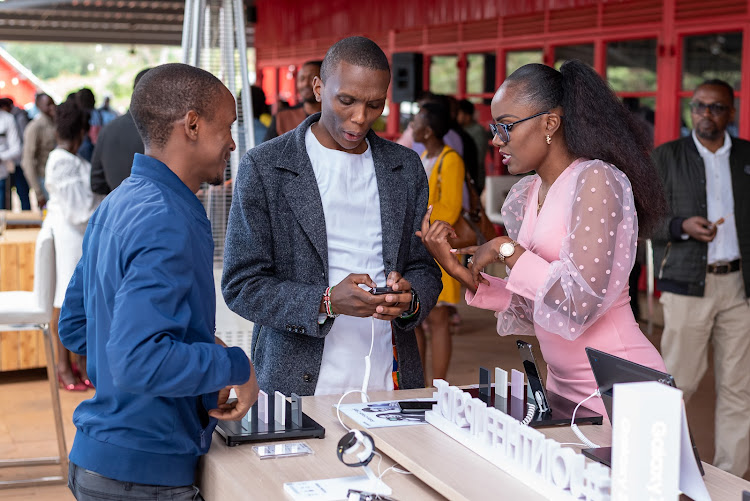 Samsung retail representative Mercy Kimutai showcases the features of the Samsung Galaxy Flip 5