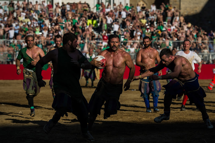 Calcio Storico Fiorentino is an early form of football, originating in the 1500s, which is still played today in Florence, Italy. The ball can be played either with feet or hands. Players can fight using tactics such as punching, elbowing and all martial arts techniques, but kicks to the head are forbidden, as are fights of two or more against one. Calcio Storico was not played for 200 years, until its revival in 1930. Picture: DAVID RAMOS/GETTY IMAGES