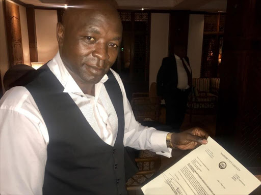 Miguna Miguna's lawyer holds the nomination letter for his client./GPS