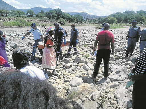 VICTIM: KwaZulu-Natal police carry the body of Thuthuka Shabalala, 28, who drowned at Tugela River near Msinga after a police chase at the weekend Photo: zethu skosana