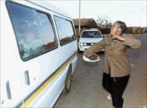CRYING SHAME: Tearful Maki Bam, a caregiver at Siyakhula Orphanage, chases after a minibus containing hysterical children removed from the orphanage after the government decided to close it down. Behind the minibus is a police escort vehicle. Pic. Len Kumalo. © Sowetan.