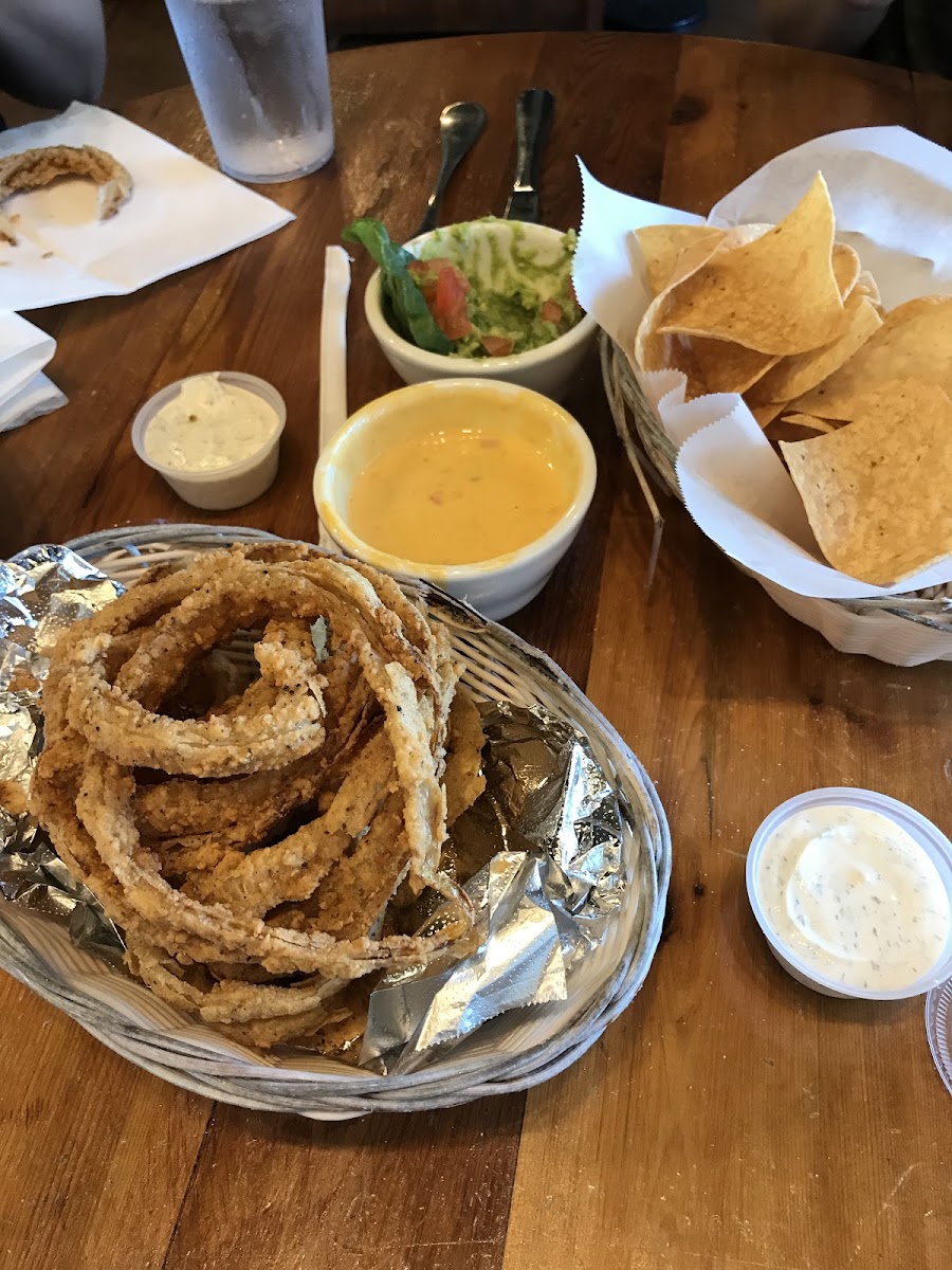 Onion rings with homemade buttermilk ranch dressing, queso and guacamole